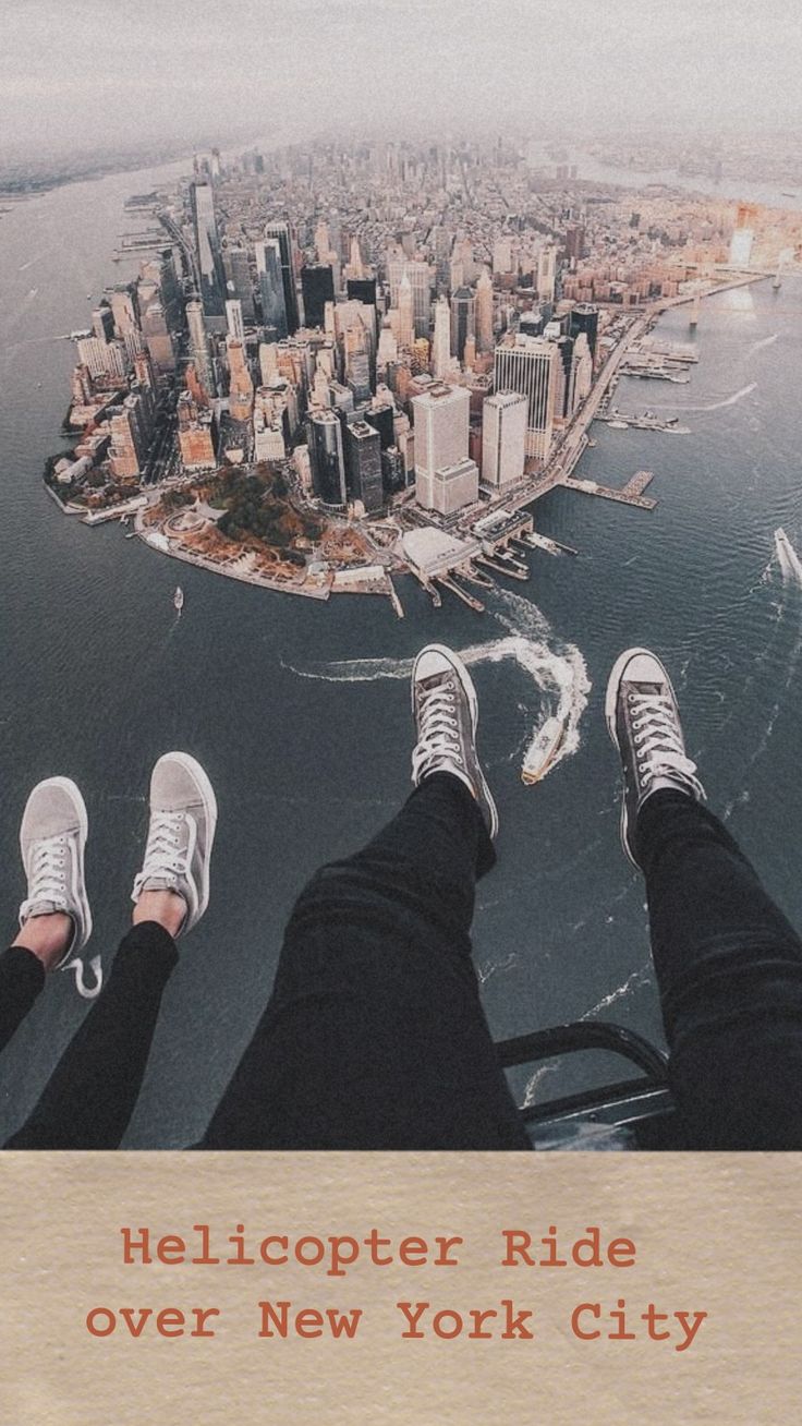 two people standing on the edge of a bridge with their feet up in the air