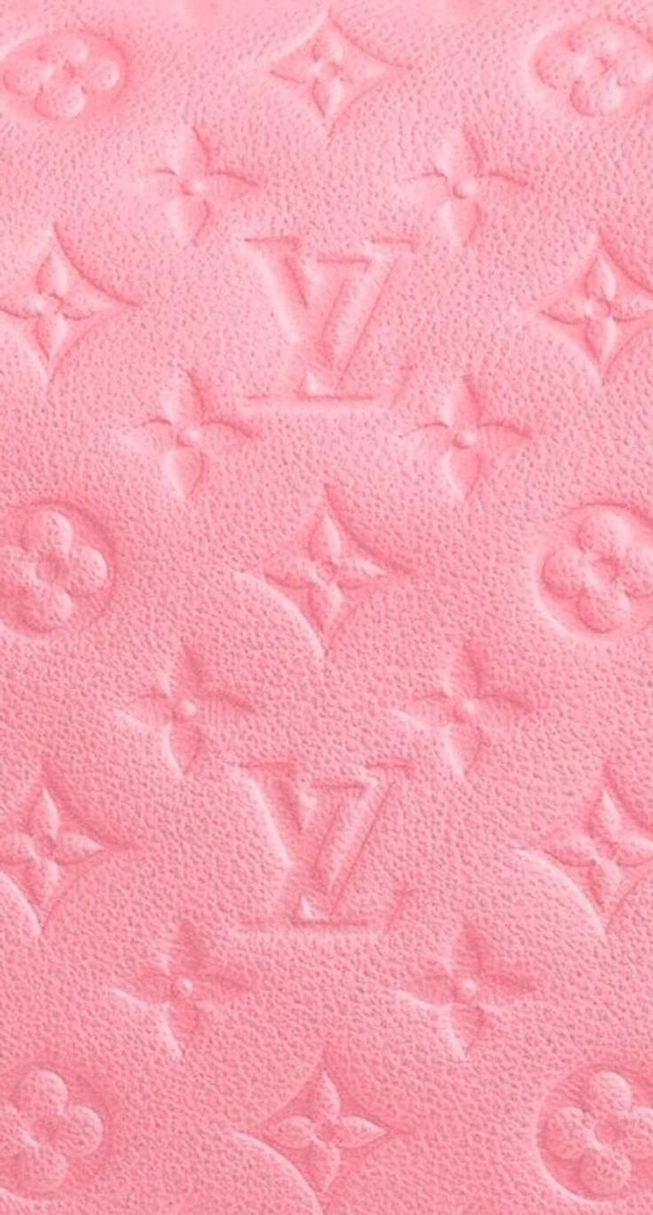 a pink background with the letters louis vuitton written in cursive writing