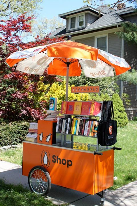 an orange and white cart with books on it