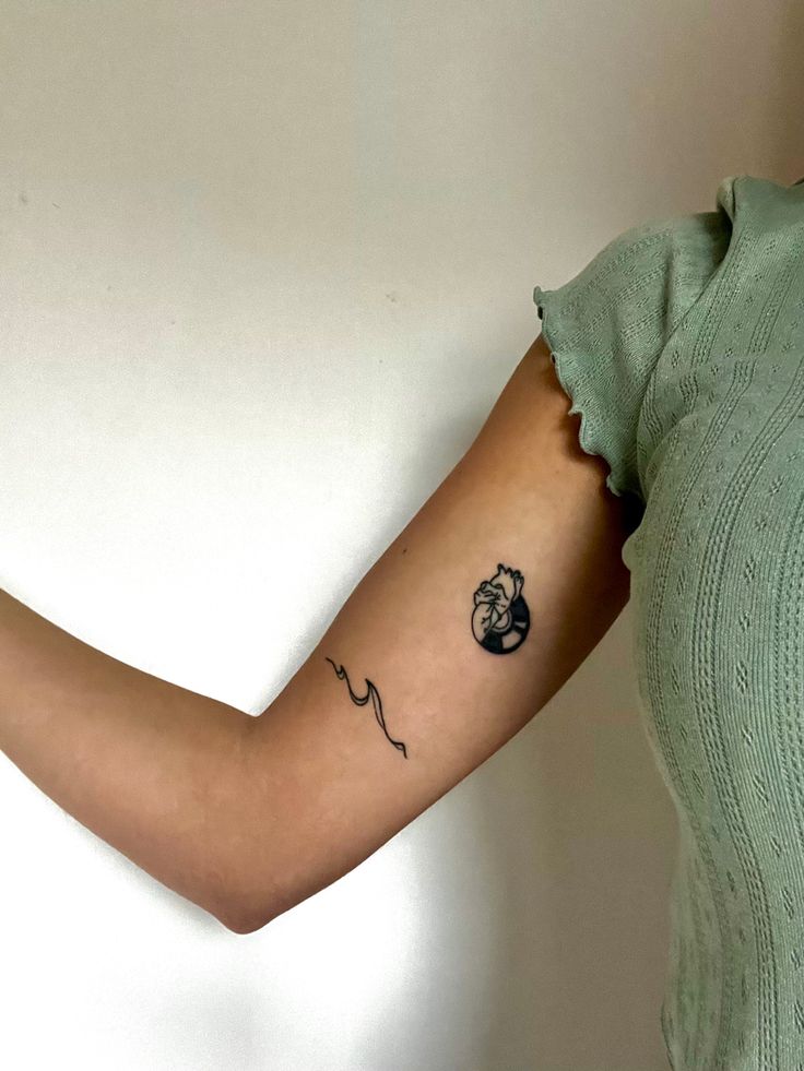 a woman with a small tattoo on her arm