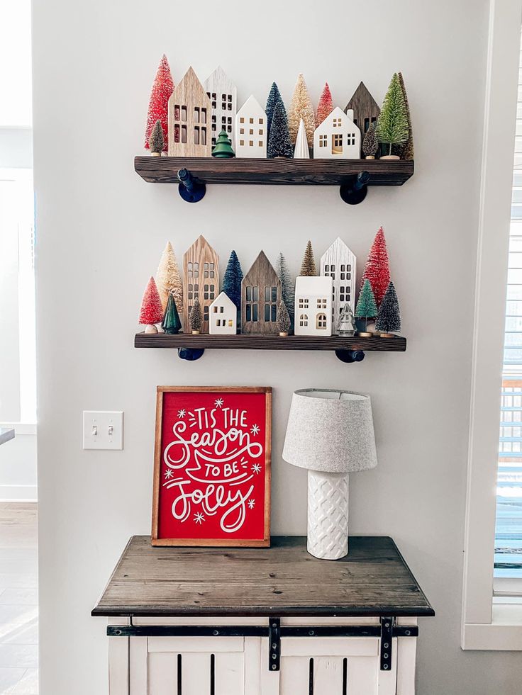 two shelves with christmas decorations on top of them