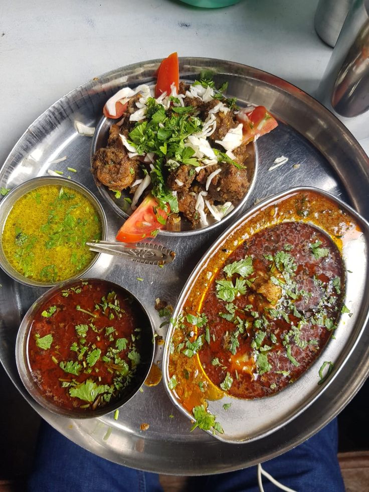 a metal tray topped with different types of food