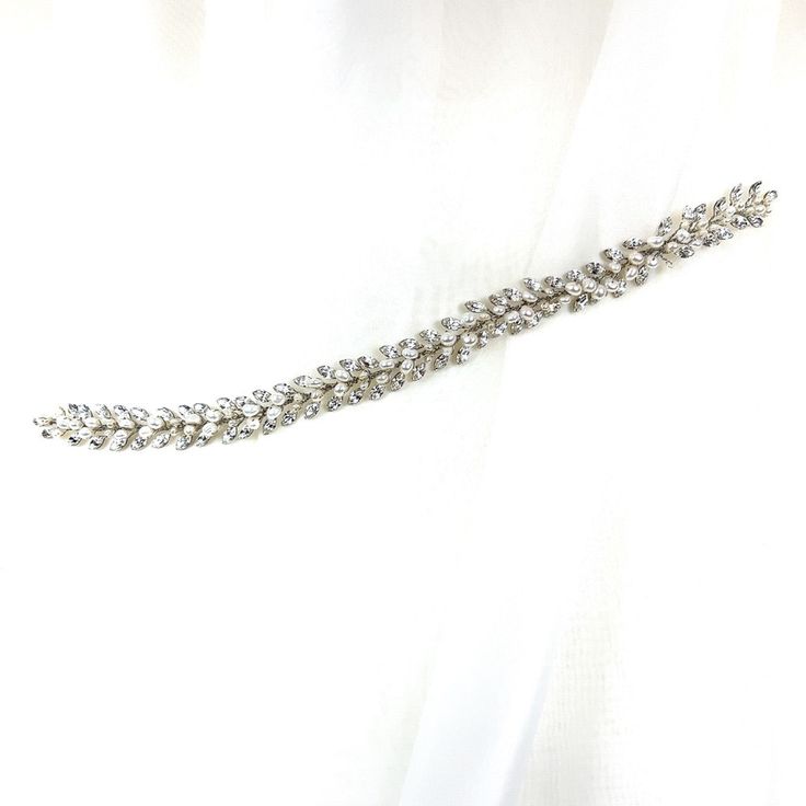 A clean cut vine of glistening crystals, this bridal hair vine radiates class and elegance. It is a simplistic way to elevate your bridal hairstyle and add a sweet sparkle to your look. Its soft and flexible structure makes this the perfect accent for many different hairstyles. Available in all crystal or crystal with pearl detailing. -Genuine crystals -Approximately 0.6in from widest point x 11.4in long (1.5cm x 29cm) -Rhodium plated non-tarnish finish for brilliance -Light and flexible for eas Adjustable Crystal Embellished Hair Accessories For Weddings, Elegant Silver Crystal Hair Accessories, Elegant Silver Hair Accessories With Rhinestones, Wedding Crystal Hair Accessories With Rhinestones, Wedding Hair Accessories With Rhinestones And Crystal, Silver Crystal Hair Accessories For Wedding, Wedding Hair Accessories With Rhinestones, Crystal Wedding Hair Accessories, Bridal Hairstyle