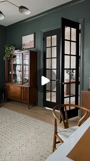 a living room filled with furniture and green walls