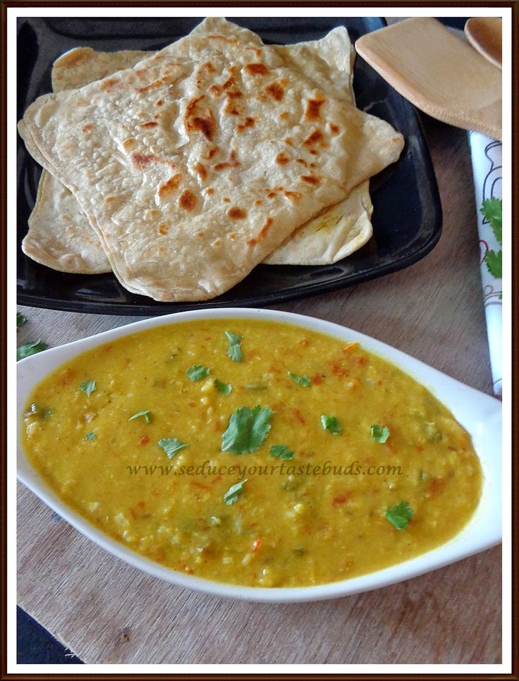 a bowl of soup with tortilla chips on the side and a plate of quesadilla