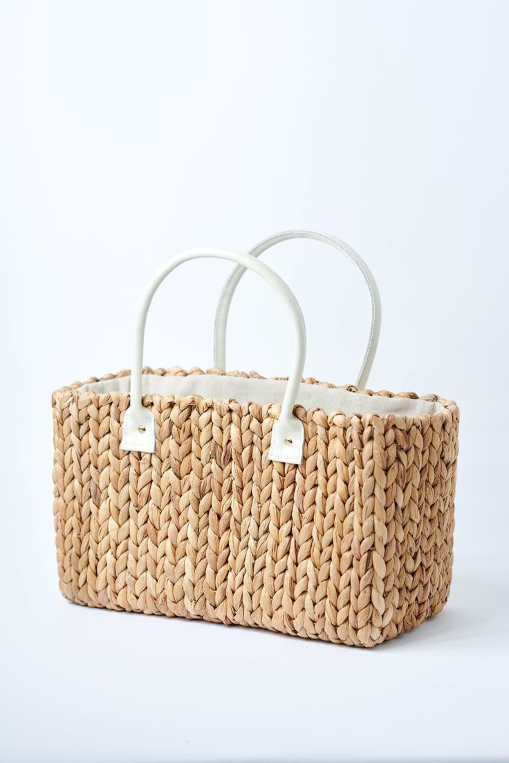 Because you fell in love with our Fullerton straw bag, we designed a second version. Buttery ivory leather, slightly smaller size and the same amazing handwoven hyacinth natural straw. This tote is topped off with a linen draw cord closure to keep your belongings secure. Fill it up with your favorite sun or pool essentials or take it to lunch. Content:Hyacinth StrawImported Size:Width: 15.5"Height: 9"Depth: 7.5"Handle Drop: 7.5" Rectangular Cream Straw Bag With Woven Leather, Cream Rectangular Woven Leather Straw Bag, Neutral Straw Bag With Braided Handles For Shopping, White Straw Bag With Bamboo Handle, White Rectangular Straw Bag With Bamboo Handle, White Natural Fiber Tote Beach Bag, White Rectangular Woven Leather Straw Bag, Eco-friendly White Bag With Natural Fiber, White Crochet Basket Bag For Shopping