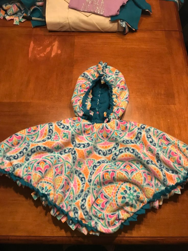 an infant's coat is sitting on top of a table