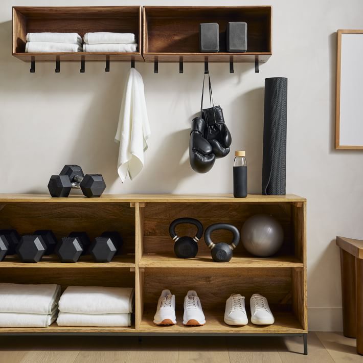 a wooden shelf filled with different types of gym equipment