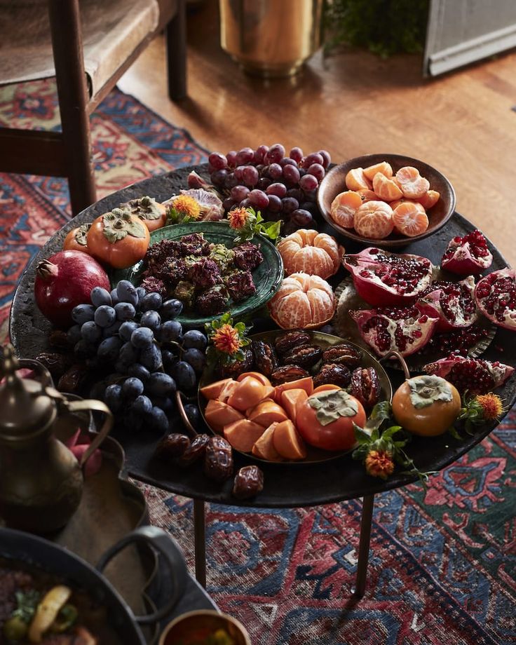 a table topped with lots of different types of fruits and veggies on top of it