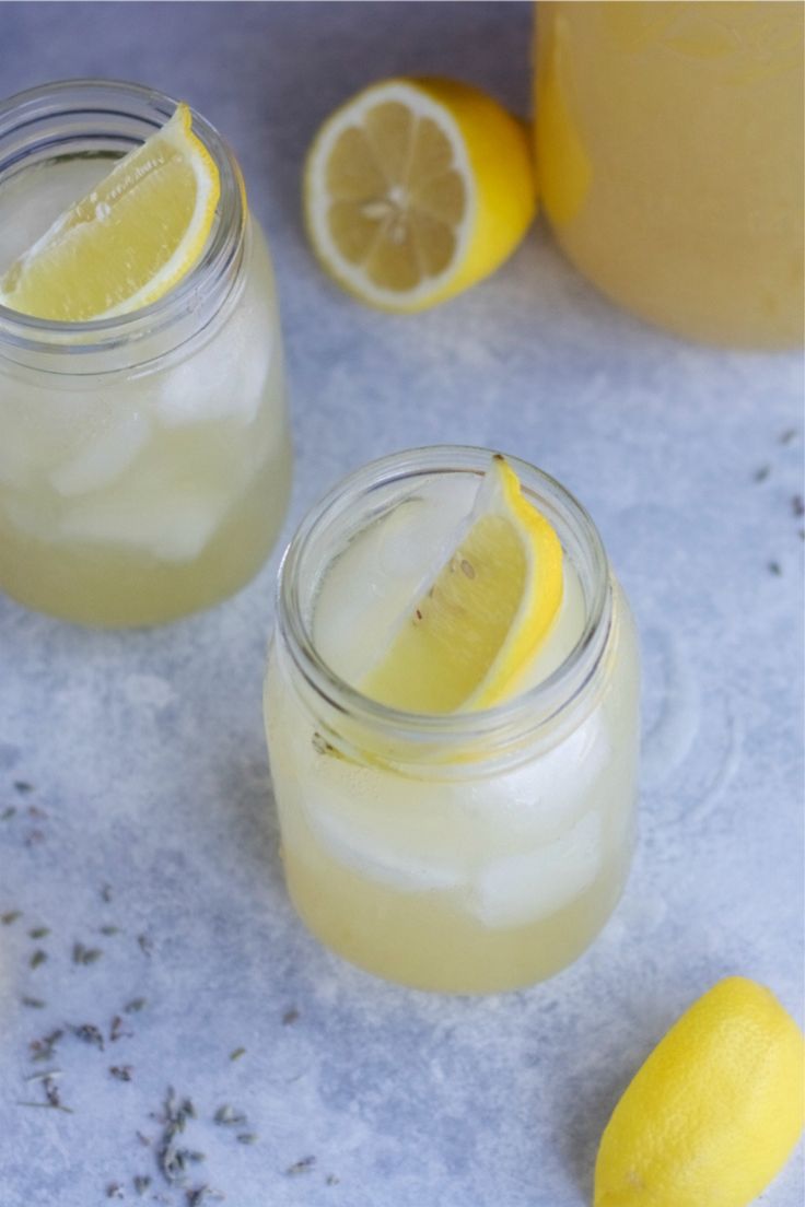 two mason jars filled with lemonade and ice