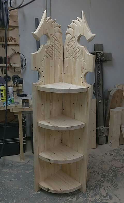 a chair made out of wood sitting on top of a wooden shelf in a shop