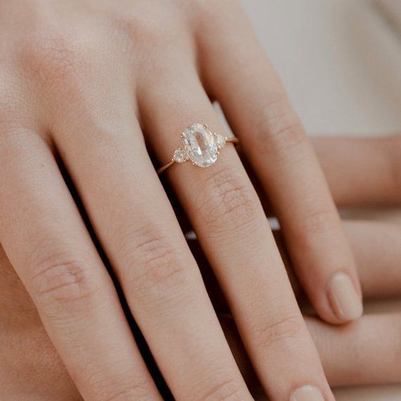 a woman's hand with a diamond ring on it