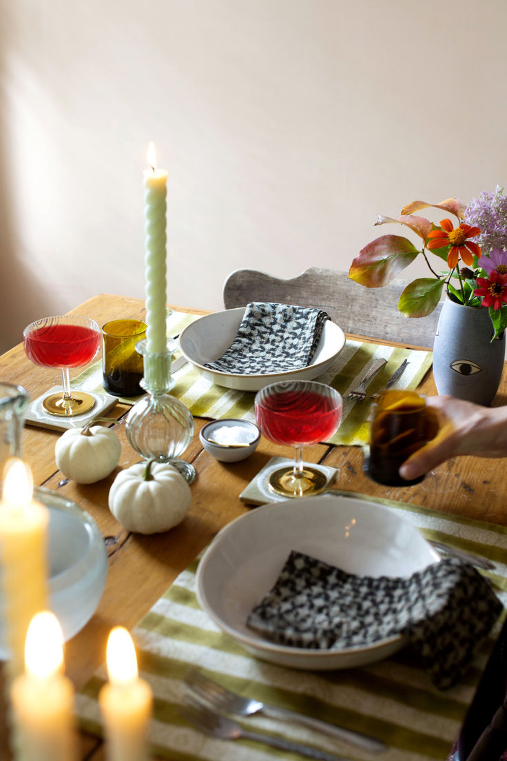 the table is set with dishes and candles