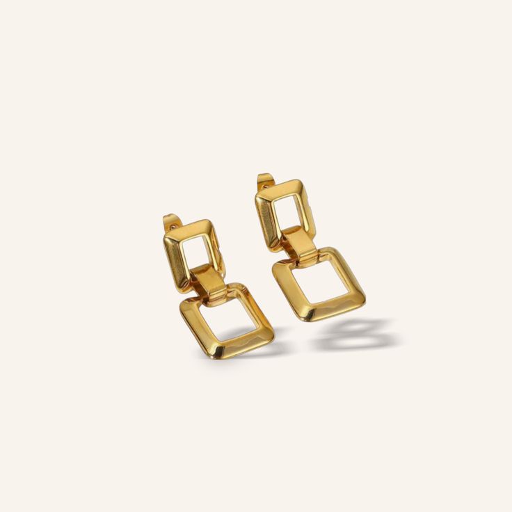 gold earrings with square links on the front and back, set against a white background