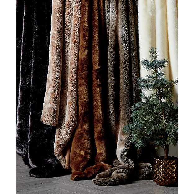 several furs are lined up next to a christmas tree