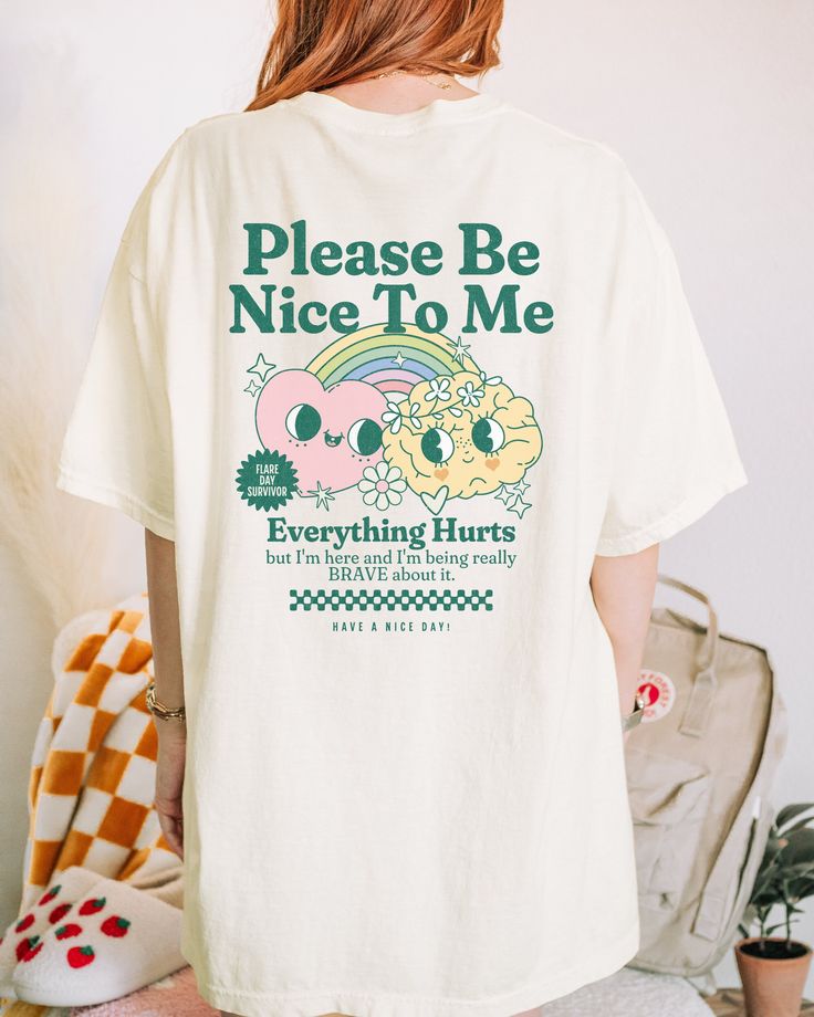 Get ready to be OBSESSED with your new Please Be Nice To Me Everything Hurts - Flare Day Comfort Colors t-shirt. It is so comfy and provides some emotional support on those really painful days. It lets everyone know how you are feeling and brings awareness to invisible diseases and chronic pain. This is the perfect gift for anyone you know that is diagnosed with a chronic illness and could use a little extra comfort. For oversized tee coziness, be sure to size up 1-2 sizes. * Q U I C K * F A C T Funny White Short Sleeve Top, Cute Relaxed Fit Slogan Shirt, White Graphic Print Cotton Top, Funny Graphic Print Crew Neck Top, Funny Short Sleeve Top With Graphic Print, Funny White Crew Neck Shirt, Cute Short Sleeve Shirt With Slogan, Cute Graphic Print White Top, Retro Short Sleeve Shirt With Front Print