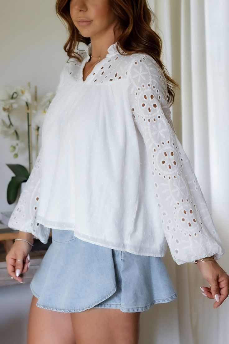 Add a touch of whimsy to your wardrobe with the Mandy Eyelet Blouse. Featuring delicate eyelet detailing, this blouse is sure to make you stand out. (Eyelet on point!) 65% Cotton 35% Polyester Color: White Long Sleeve Blouse All Over Eyelet Detail Light Weight Elastic Wrist Detail Double Lined in all the right placed Relaxed Flowy Style Ruffle Collar Detail Model is wearing a size Small. She is 5'6". 130lbs. Bust: 34" Waist 26" Hips 36" Flowy Style, Bottom Workout, Eyelet Blouse, White Long Sleeve Blouse, Ruffle Collar, Dressy Tops, Swimwear Sale, Dressy Casual, Outerwear Sweater