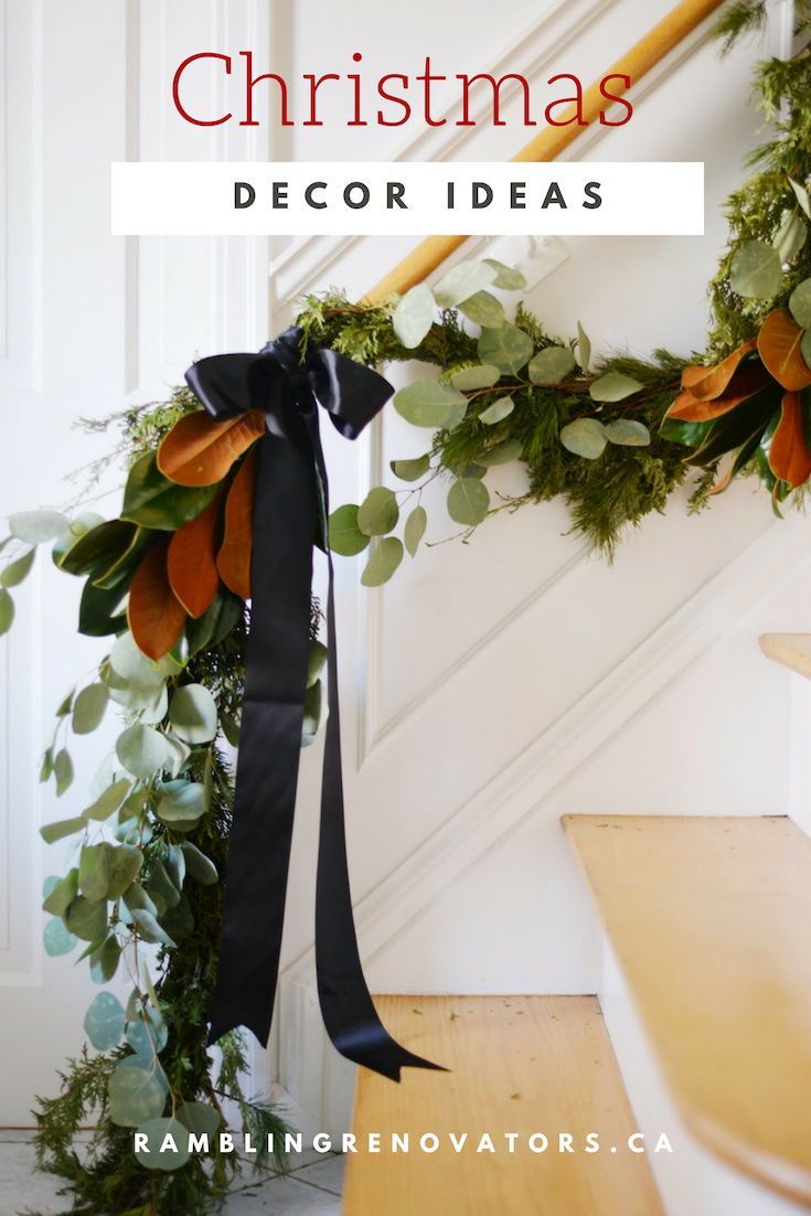 a black ribbon is tied to the banister and decorated with greenery on it