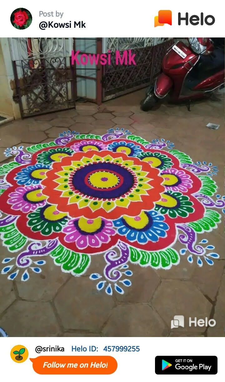 an image of a colorful flower design on the ground in front of a motor scooter