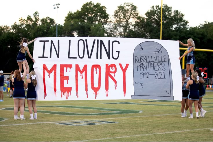 the cheerleaders are holding up a sign that says in loving memory