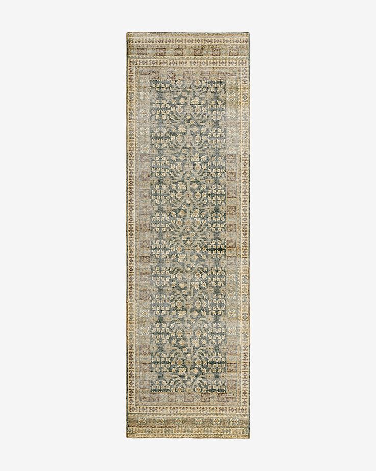 a beige and green rug with an intricate design on the bottom, in front of a white background