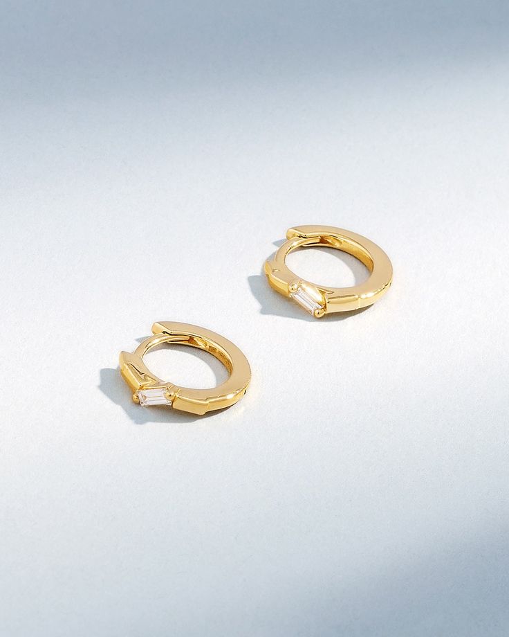 Crafted in 18-karat gold, these huggies feature baguette white diamonds. Lightweight and comfortable, they'll bring some sparkle to your daily look. Details 18k yellow gold, rose gold or white gold 0.10 carats of baguette white diamonds 12mm diameter 3mm width Ref: BAE888 Diamond Huggie Earrings, Diamond Huggies, Baguette Diamond, Huggies Earrings, Diamond White, Sparkle, Rose Gold, Yellow Gold, White Gold