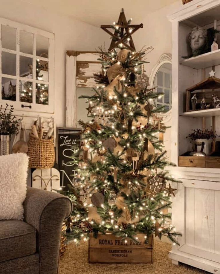 a decorated christmas tree in a living room with lights and ornaments on the top shelf