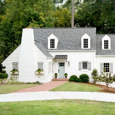 a white house with black shutters and windows