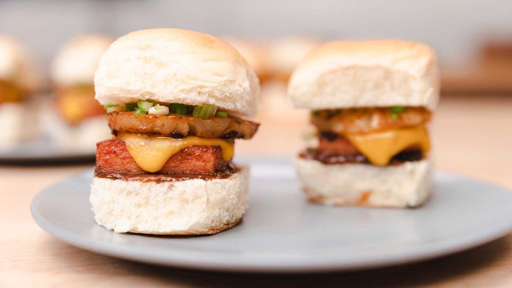 three mini sandwiches with meat and cheese on them