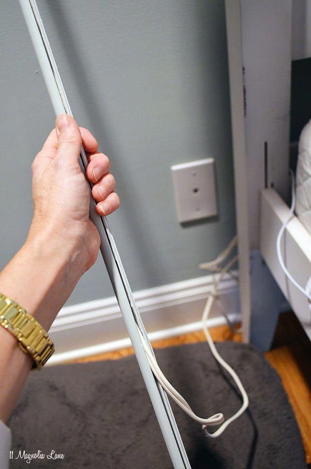 a person is holding a white pole in their hand and plugged into the wall