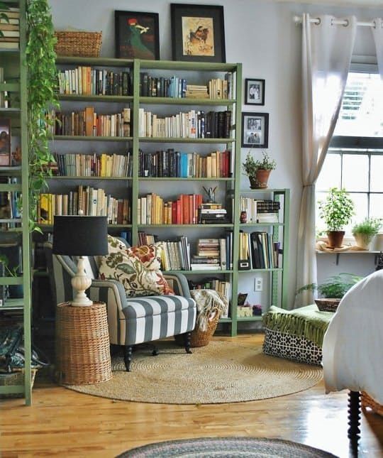 a living room filled with furniture and bookshelves full of different types of books