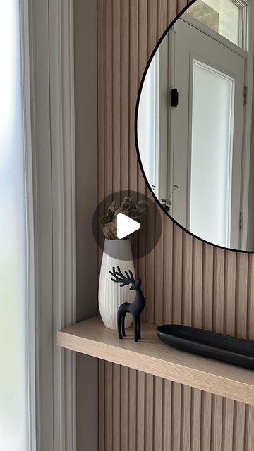 a mirror on a shelf next to a window