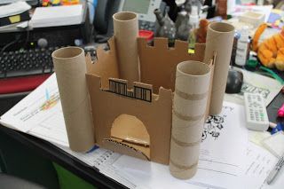 a cardboard castle sitting on top of a desk