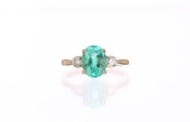 A classic Colombian emerald and diamond three stone ring. Dexterously crafted in gleaming 14K gold this ring features a 2.0-carat natural Colombian emerald-oval cut from the famous Chivor mines. Set in a secure prong setting, this extraordinary emerald has a bright green color and glow. This emerald has very good eye clarity with natural Jardins that occur in all earth mined emeralds. Brilliant round diamonds weighing 0.35pts total accent either side of the emerald. Setting: Three-Stone Metal Pu Classic Three Stone Emerald Jewelry, Luxury Oval Three Stone Emerald Ring, Luxury Oval Emerald Ring With Three Stones, Fine Jewelry With Oval Three Stone, Oval Emerald Three-stone Diamond Ring, Oval Emerald Three Stone Diamond Ring, Oval Three-stone Emerald Ring For Formal Occasions, Oval Three Stone Emerald Ring For Formal Occasions, Oval Emerald Diamond Ring With Three Stones