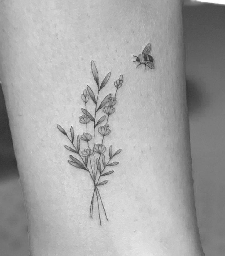 a black and white photo of a flower on the ankle