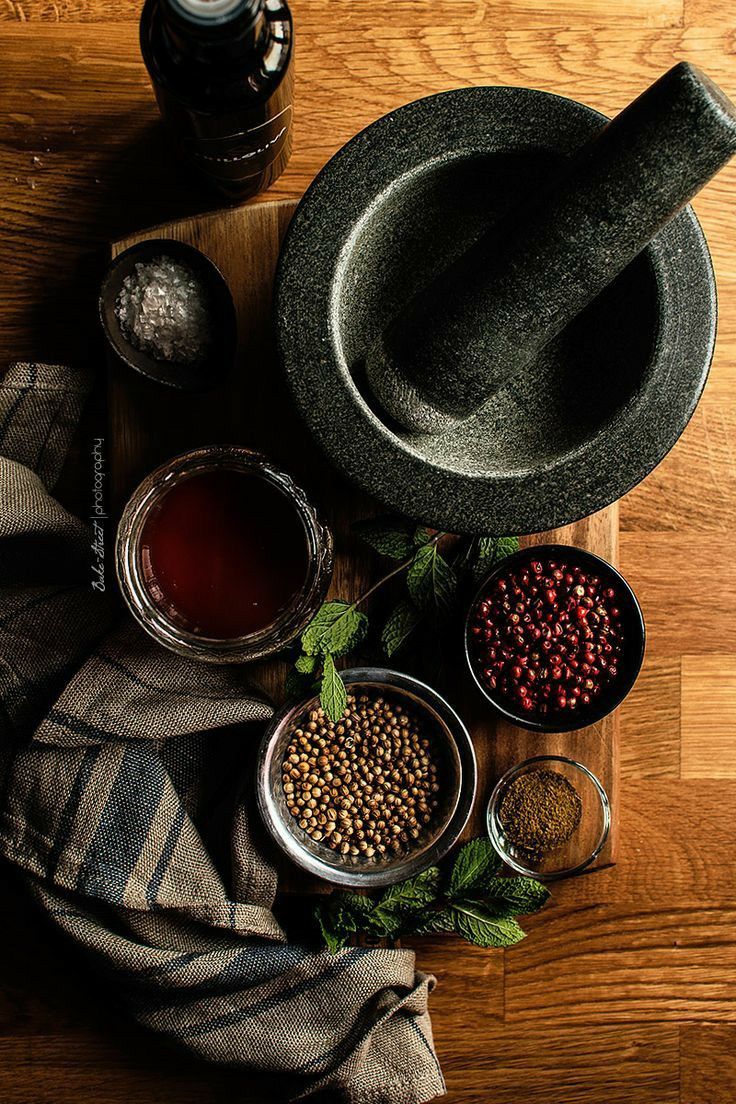 an assortment of spices and seasonings on a wooden table