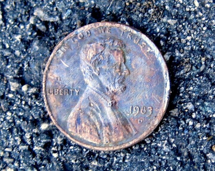 an old penny is laying on the ground