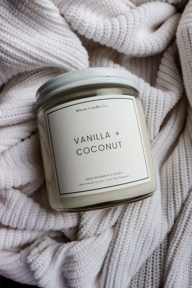 vanilla and coconut candle on a white blanket