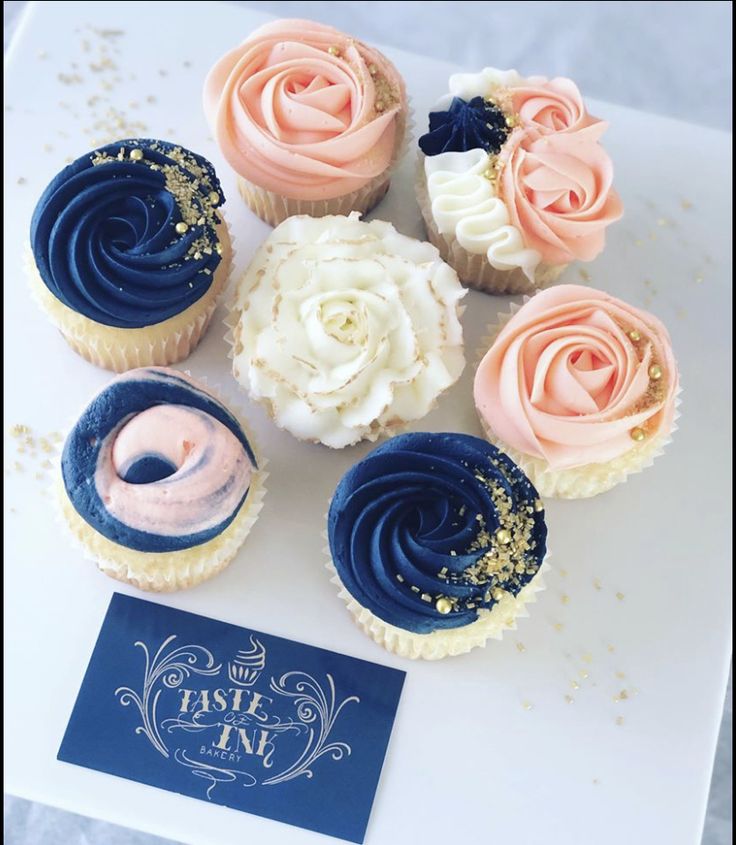 cupcakes with frosting and sprinkles are arranged on a table