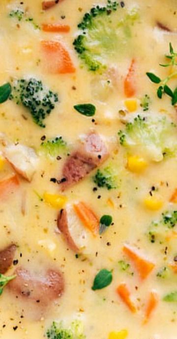 a casserole dish with broccoli, carrots, corn and meat