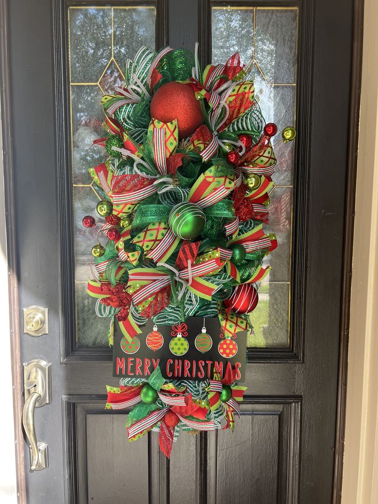 a christmas wreath hanging on the front door