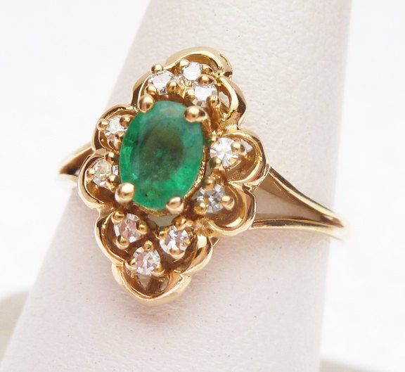 This is a very nice emerald in this ring. The ring has an oval cut green emerald in the center that measures 5.6 x 4.2 mm. The emerald has a nice bright green color and medium clarity. The ring also has 10 single cut round diamonds that have a combined weight of 0.10 carats in all. Diamonds have VS clarity and H color. The inside of the ring is stamped 14KP and the ring weighs 3.1 grams. Ring is a size 6.5. Heirloom Oval Green Emerald Ring, Heirloom Oval Emerald Ring As May Birthstone, Oval Green Emerald Ring For May Birthstone, Bright Green Color, Orange Stone, Rings Cool, Green Emerald, Bright Green, Oval Cut