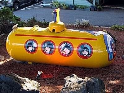 a yellow submarine shaped object sitting on the ground