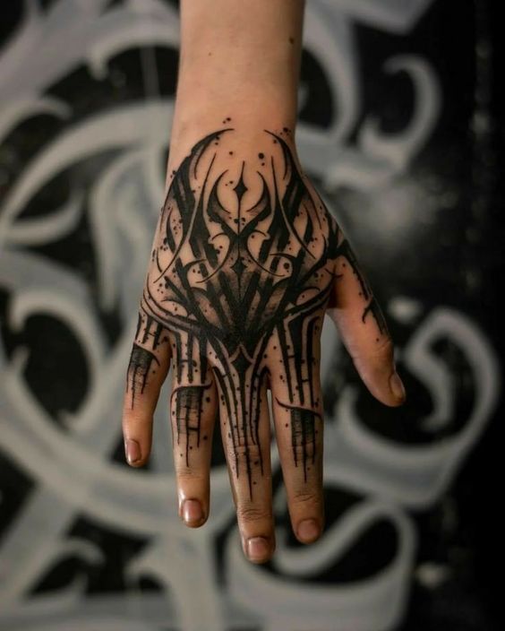 a person's hand with black ink on it and some designs on the palm