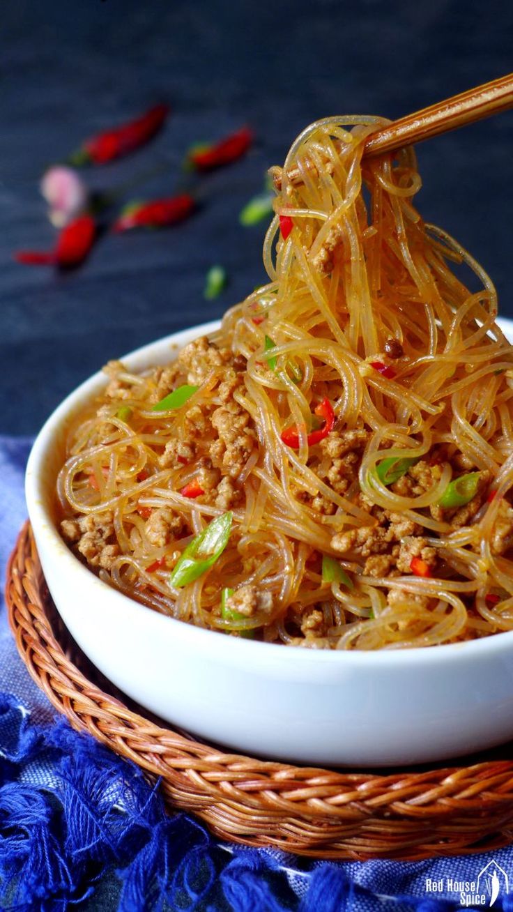 a bowl of noodles with chopsticks in it