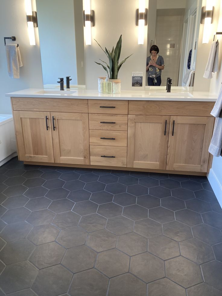 a bathroom with two sinks and a large mirror