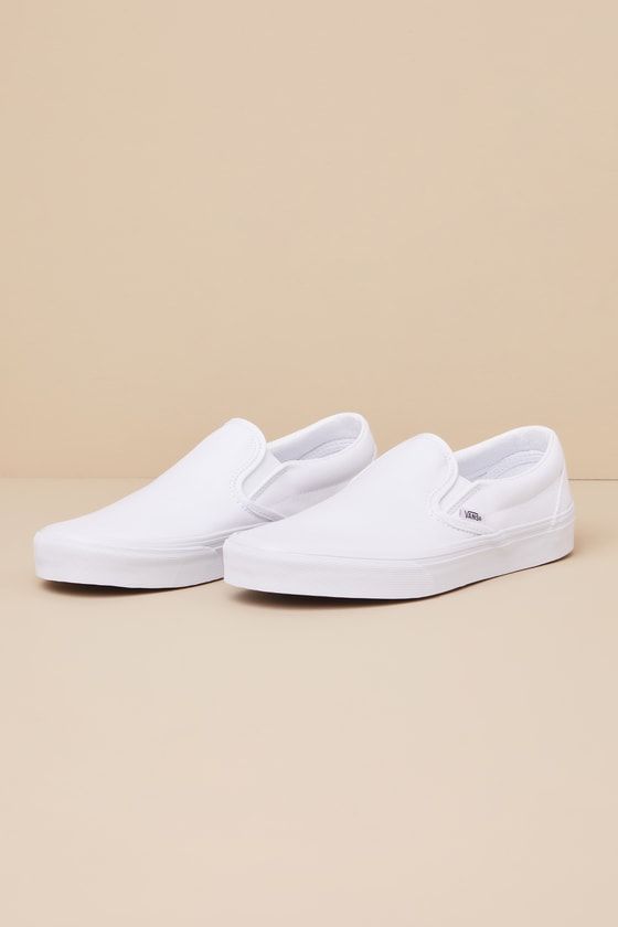 You'll reach for the Vans Classic True White Slip-On Sneakers time and time again when you want to create casually cool looks! These timeless sneakers have a sturdy canvas construction that creates a sleek silhouette with a rounded toe upper, elastic gussets at the sides, and a low-cut, padded collar. The effortless slip-on design makes these shoes essential when you have places to go and things to do! Logo tag at the outstep and heel. 1" rubber sole. Lightly cushioned insole. Rubber sole has no Casual White Slip-ons With Contrast Sole, Slip-on Canvas Shoes With Vulcanized Sole For Streetwear, White Vulcanized Sole Slip-ons For Streetwear, High-top Slip-ons With Vulcanized Sole For Streetwear, High-top Slip-ons For Streetwear, Canvas Shoes With Cushioned Footbed For Streetwear, Casual White Slip-ons For Streetwear, High-top Canvas Slip-on Sneakers For Streetwear, Slip-on Canvas Shoes With Cushioned Footbed For Streetwear