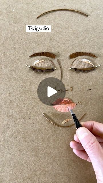 someone is drawing a face on cardboard with scissors and glue to make it look like a woman's face