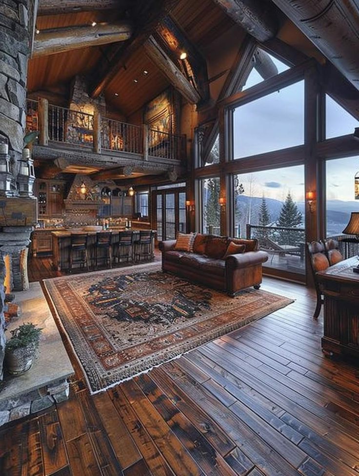 a living room filled with furniture and a fire place in the middle of a wooden floor