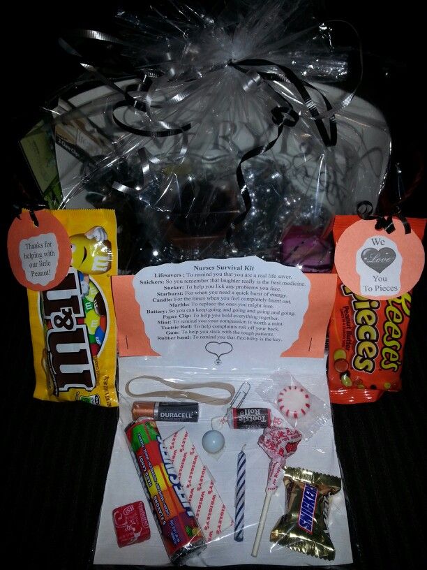 an assortment of candy and candies in a gift bag on a black tablecloth